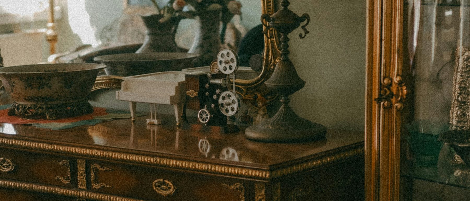 An antique sideboard and mirrored cabinet in a period interior