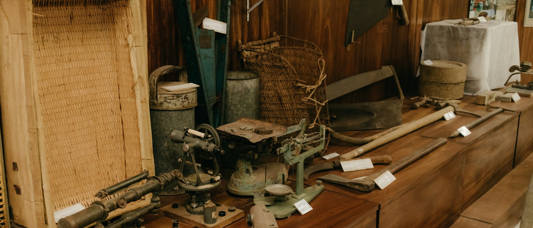 Antique tools, scales and instruments laid out and tagged for cataloguing